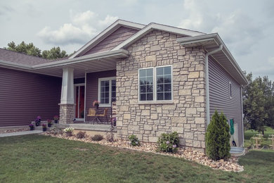 Example of an arts and crafts brown one-story vinyl house exterior design in Cedar Rapids with a shingle roof