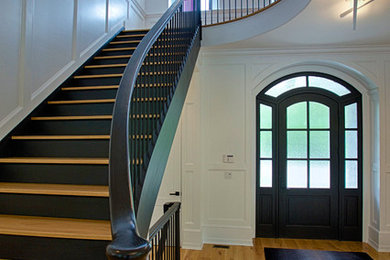 Inspiration for a large traditional wood straight staircase in New York with painted wood risers and mixed railing.