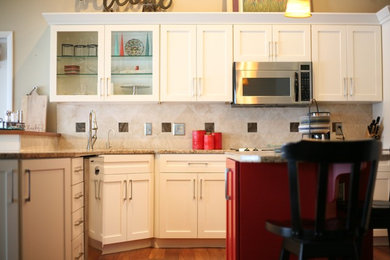 Eat-in kitchen - large transitional l-shaped eat-in kitchen idea in Grand Rapids with shaker cabinets, white cabinets and an island