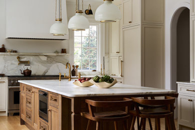 Inspiration for a large timeless u-shaped light wood floor, brown floor and wood ceiling eat-in kitchen remodel in New York with a single-bowl sink, recessed-panel cabinets, beige cabinets, marble countertops, white backsplash, marble backsplash, paneled appliances, an island and white countertops
