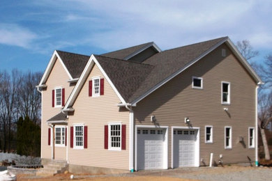 Inspiration for a mid-sized victorian beige two-story vinyl exterior home remodel in New York with a shingle roof