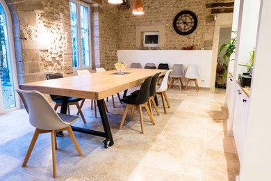 Inspiration for an industrial dining room in Lyon with travertine floors and beige floor.