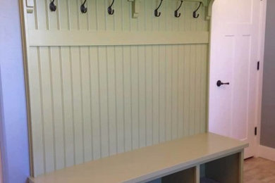 Mudroom - mid-sized traditional light wood floor mudroom idea in Denver with gray walls