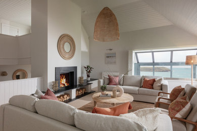 This is an example of a beach style living room in Cornwall.