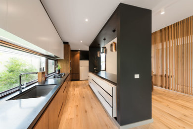 Design ideas for a mid-sized contemporary galley open plan kitchen in Melbourne with granite benchtops and with island.