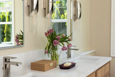 Example of a large master double-sink bathroom design in Seattle with recessed-panel cabinets, medium tone wood cabinets, an undermount sink, quartz countertops, white countertops and a built-in vanity