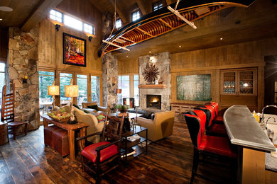 Example of a mountain style living room design in San Francisco with a standard fireplace and a stone fireplace