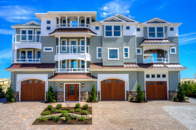 Beach style four-story house exterior photo in New York with a metal roof