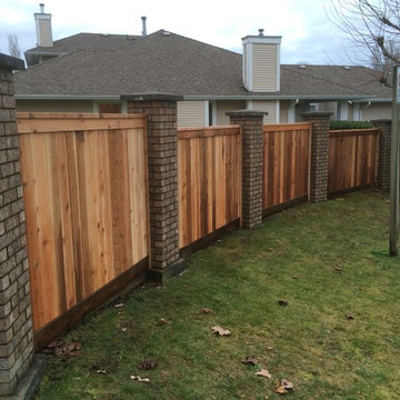 North Delta Curved Fence Between Brick Columns