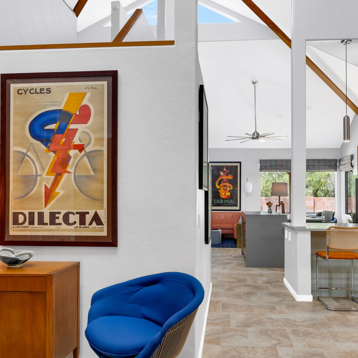 Make a grand entrance every day with this beautifully designed entryway. Featuring bold colors and unique decor. A locally-sourced vintage console hides shoes and slippers out of view.
