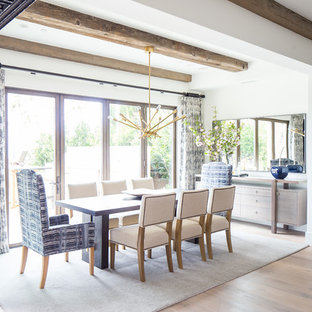 Inspiration for a large mediterranean open plan dining in Orange County with white walls, medium hardwood floors, no fireplace and brown floor.