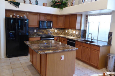 Inspiration for a ceramic tile eat-in kitchen remodel in Phoenix with an undermount sink, light wood cabinets, granite countertops, black appliances and an island