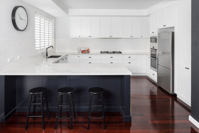 Design ideas for a traditional kitchen in Perth with shaker cabinets, white cabinets, quartz benchtops, white splashback, ceramic splashback, stainless steel appliances and white benchtop.