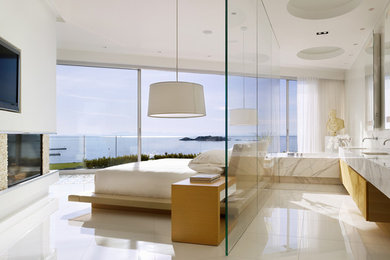 Example of a trendy master white floor bedroom design in Vancouver with white walls and a standard fireplace