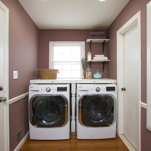 Small traditional single-wall separated utility room in New York with wood worktops, purple walls, medium hardwood flooring and a side by side washer and dryer.