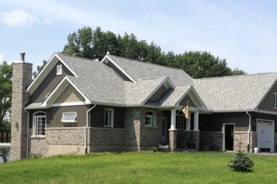 Photo of a mid-sized traditional one-storey grey exterior in Toronto with mixed siding.