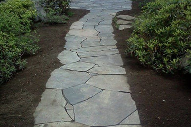 Design ideas for a mid-sized backyard full sun garden in Portland Maine with a garden path and natural stone pavers.