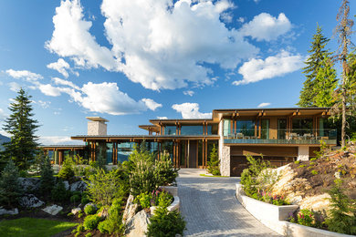 Inspiration for a huge contemporary brown two-story flat roof remodel in Vancouver