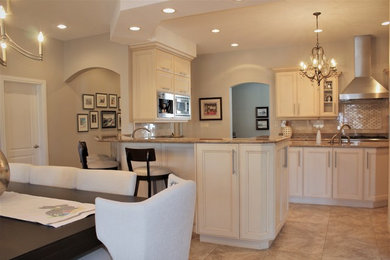 Large elegant u-shaped ceramic tile and multicolored floor eat-in kitchen photo in Other with an undermount sink, recessed-panel cabinets, beige cabinets, granite countertops, multicolored backsplash, marble backsplash, stainless steel appliances, an island and multicolored countertops