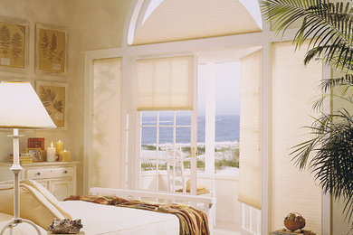Inspiration for a mid-sized coastal master light wood floor and white floor bedroom remodel in San Diego with beige walls and no fireplace