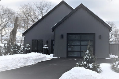 Design ideas for a medium sized and gey contemporary bungalow detached house in Milwaukee with metal cladding, a pitched roof, a shingle roof and a black roof.
