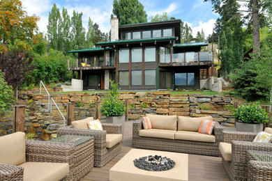 Example of a mid-sized mountain style backyard patio design in Vancouver with decking