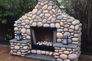 Patio - large eclectic backyard stamped concrete patio idea in Calgary with a fire pit and a pergola