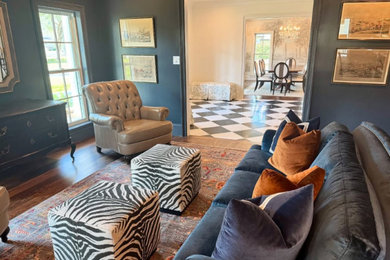 Living room library - mid-sized transitional enclosed dark wood floor and brown floor living room library idea in Houston with blue walls, a standard fireplace, a brick fireplace and no tv