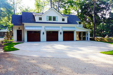 Garage - large traditional detached three-car garage idea in Other