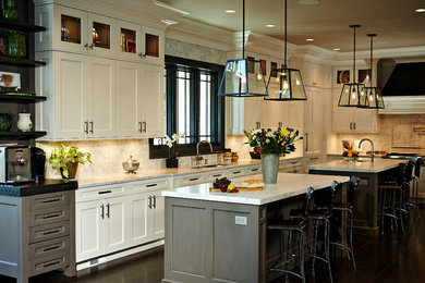 Mid-sized elegant u-shaped dark wood floor and brown floor eat-in kitchen photo in New York with an undermount sink, recessed-panel cabinets, white cabinets, quartzite countertops, white backsplash, stone tile backsplash, stainless steel appliances and two islands