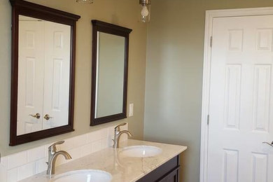 Inspiration for a mid-sized transitional master ceramic tile bathroom remodel in Boise with shaker cabinets, dark wood cabinets, beige walls, an undermount sink and quartz countertops