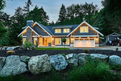 Example of a mid-sized transitional gray two-story wood exterior home design in Vancouver with a shingle roof