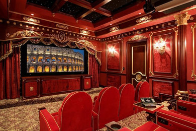 Large traditional enclosed home theatre in Denver with red walls, carpet, a projector screen and multi-coloured floor.