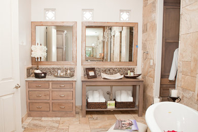 Inspiration for a large traditional master bathroom in Dallas with open cabinets, medium wood cabinets, a freestanding tub, beige tile, porcelain tile, white walls, porcelain floors, a vessel sink, granite benchtops, beige floor and multi-coloured benchtops.