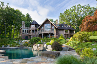 Example of a large mountain style brown two-story mixed siding exterior home design in New York with a shingle roof