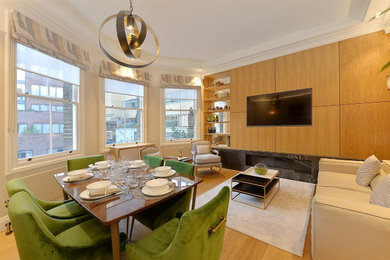 Photo of a contemporary enclosed dining room in Other with grey walls and light hardwood flooring.