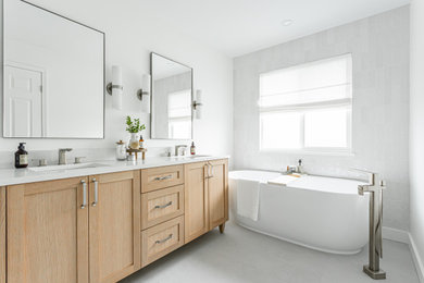 Large beach style master gray tile and ceramic tile ceramic tile, gray floor and double-sink bathroom photo in Vancouver with shaker cabinets, light wood cabinets, a one-piece toilet, white walls, an undermount sink, quartz countertops, a hinged shower door, white countertops, a niche and a freestanding vanity