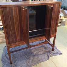 The cabinet is not huge and yet hides the TV
