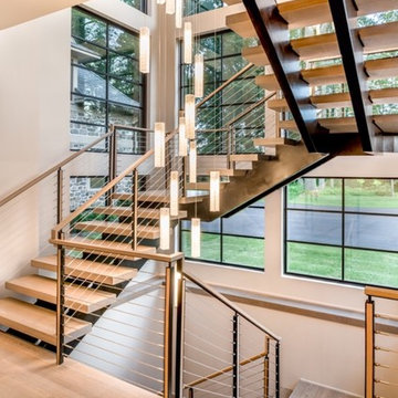 Vaddi - floating double steel center stringer with cable railing
