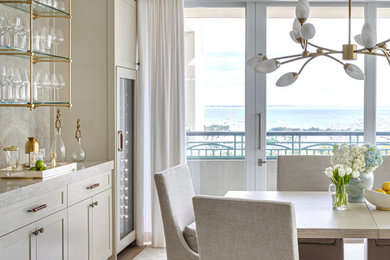 Mid-sized transitional vinyl floor and wallpaper dining room photo in Miami with beige walls
