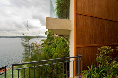 Photo of a mid-sized contemporary two-storey beige exterior in Sydney with stone veneer.
