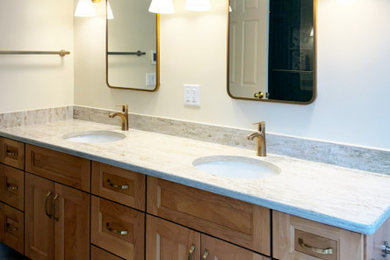 Master green tile and porcelain tile double-sink, porcelain tile and gray floor bathroom photo in Boston with shaker cabinets, medium tone wood cabinets, quartzite countertops, beige countertops, a built-in vanity, an undermount sink, a hinged shower door, a two-piece toilet, beige walls and a niche