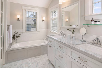 Design ideas for a small transitional master bathroom in Santa Barbara with recessed-panel cabinets, white cabinets, a drop-in tub, an alcove shower, white tile, ceramic tile, white walls, marble floors, an undermount sink and granite benchtops.