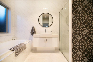 Inspiration for a mid-sized contemporary bathroom in Adelaide with flat-panel cabinets, white cabinets, an alcove tub, an alcove shower, white tile, marble, white walls, marble floors, a trough sink and granite benchtops.