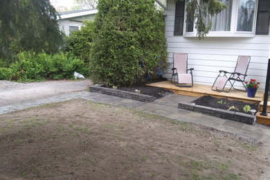 Small elegant brick metal railing front porch photo in Ottawa