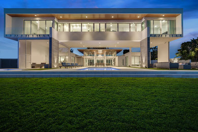 Patio - large modern backyard patio idea in Tampa