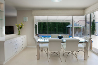 Design ideas for a mid-sized modern kitchen/dining combo in Perth with porcelain floors.