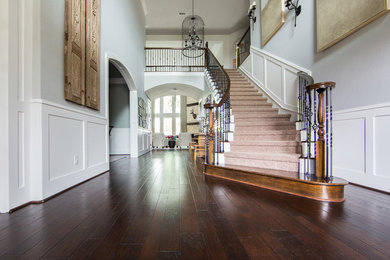 Photo of a mid-sized transitional foyer in Houston with grey walls, dark hardwood floors and brown floor.