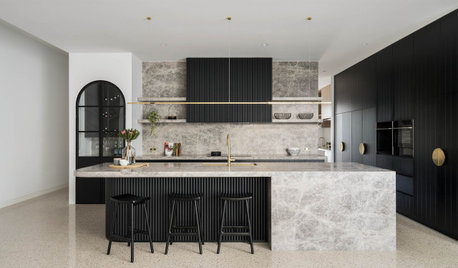 Kitchen Tour: Black Cabinetry and Pale Marble Create a Luxe Look