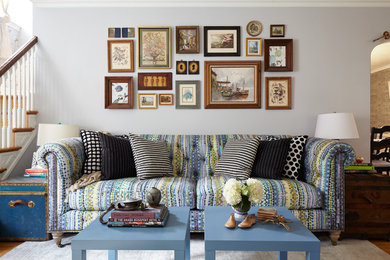 Living room - large eclectic enclosed light wood floor living room idea in Philadelphia with blue walls, a standard fireplace, a brick fireplace and no tv